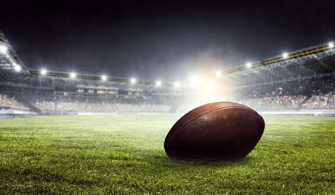 American football ball on the arena's field