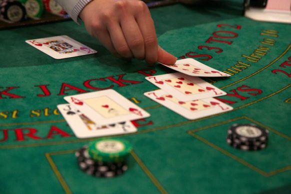 Dealer deals the playing cards at a blackjack table