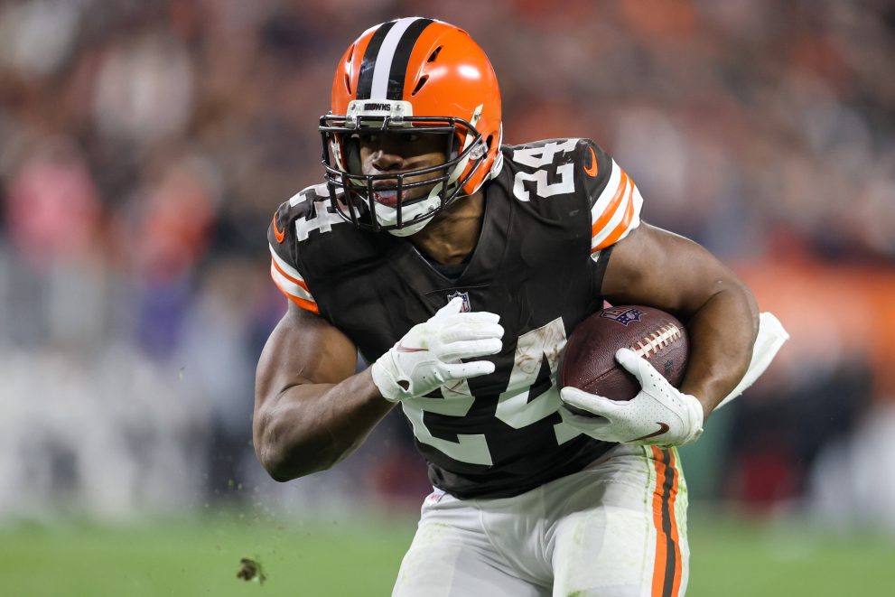 American football player carries the ball during a game