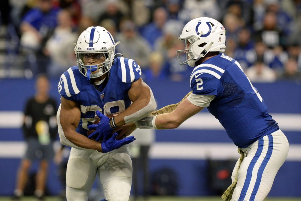 American football player passes the ball during a match