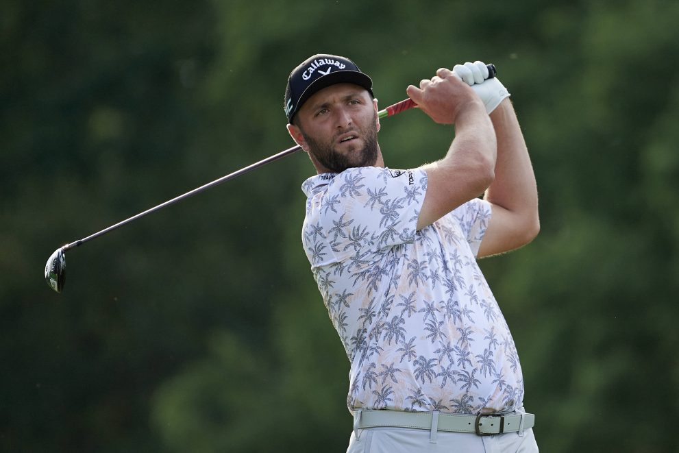 Golf player watches his tee shot during a golf game