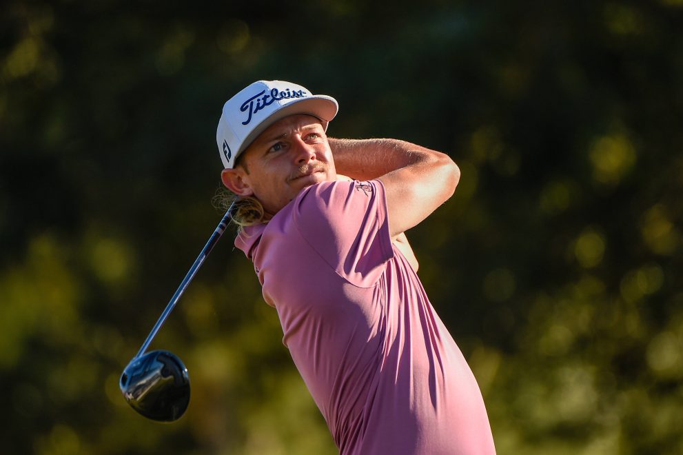 Golf player watches his tee shot during a golf game