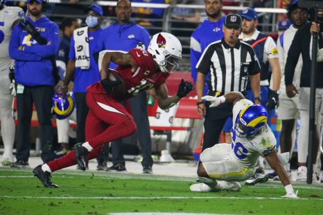 American football player runs after a catch during a game