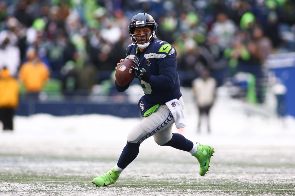 American football player rolls out to pass the ball during a game