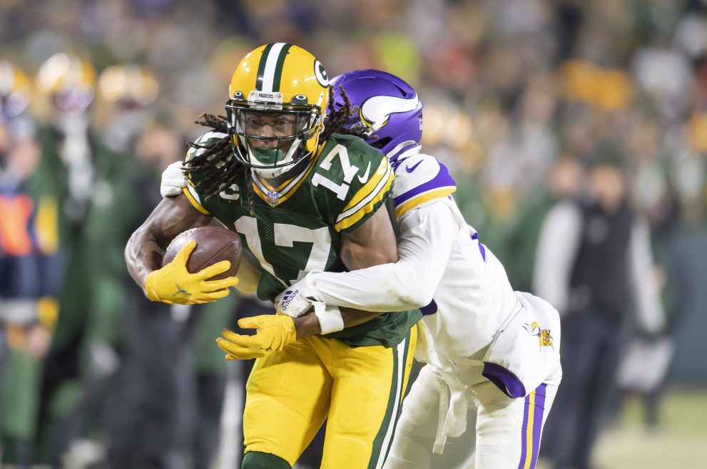 American football players battle for the ball during a game