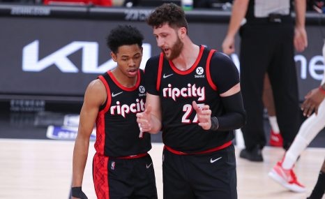 Basketball players talk during a game