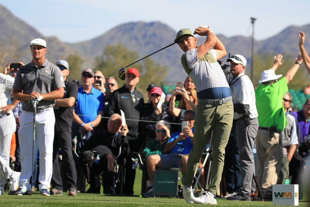 Golf player tees off on a hole during a golf game