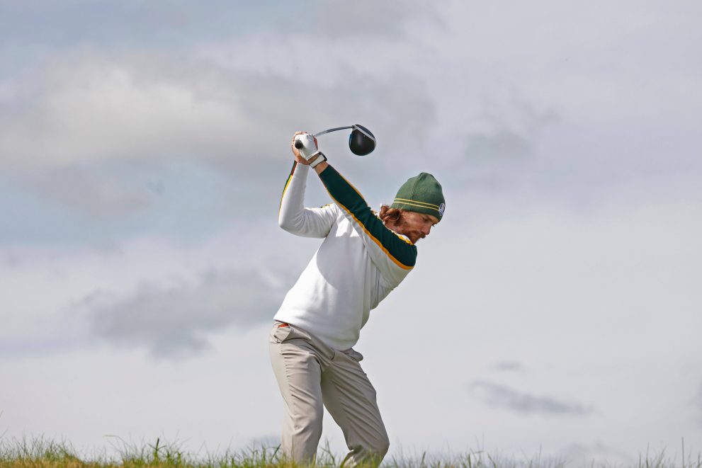 Golf player before hitting a tee shot at a hole during a game