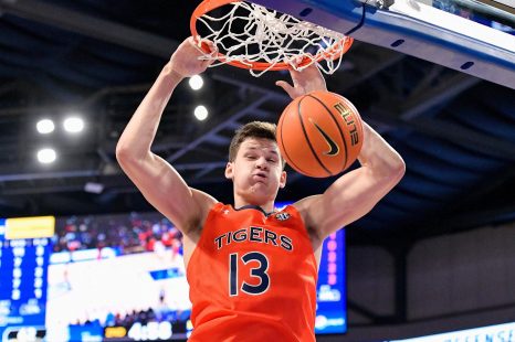 Basketball player dunks the basketball during a game