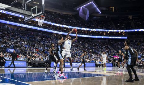 Basketball player goes strong to the basket during a game