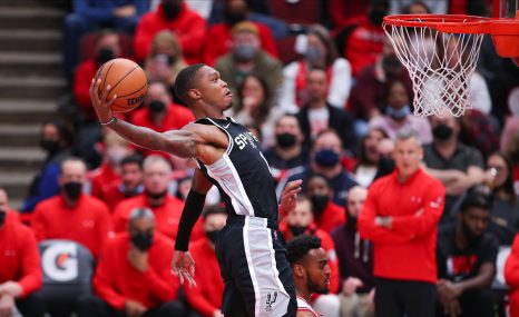 Basketball player in action before slam-dunking the ball during a NBA