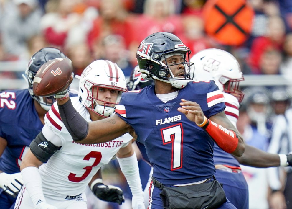 American football player makes a pass during a match