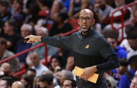 Coach reacts during a basketball game