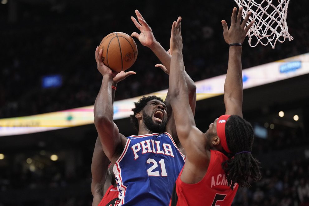 Basketball player jumps towards the basket during a basketball game