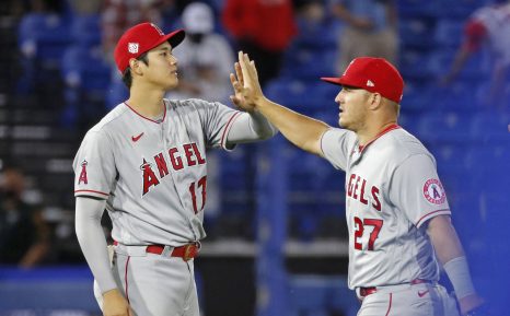 Two baseball players high-five after the game