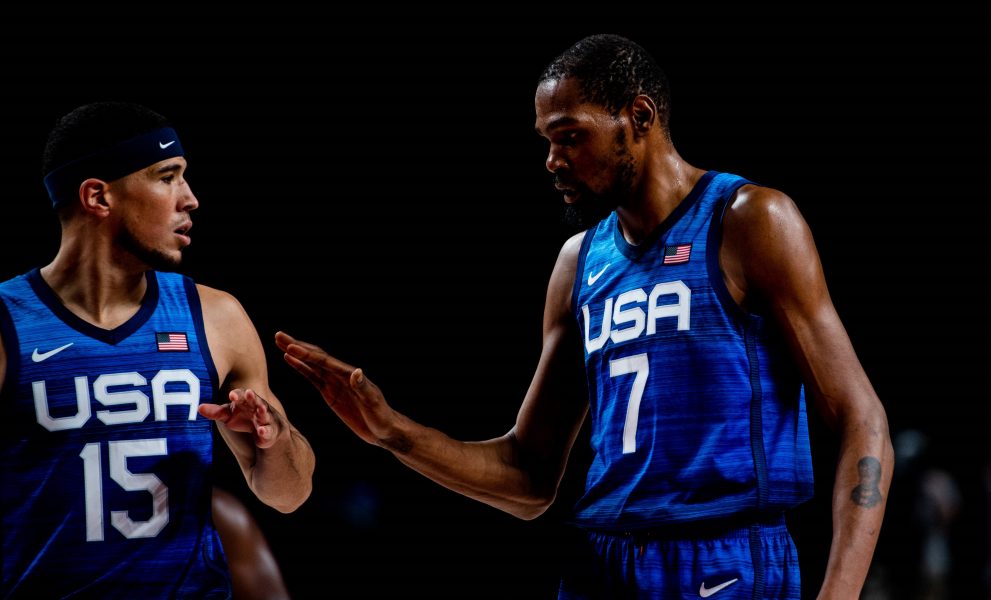 Two basketball players talk during a match