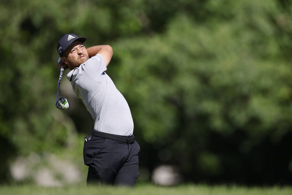 Golf player hits a tee shot at one of the holes during a golf game