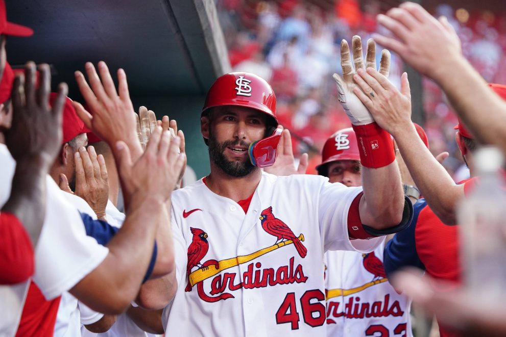 A baseball player is welcomed in the dugout after the game