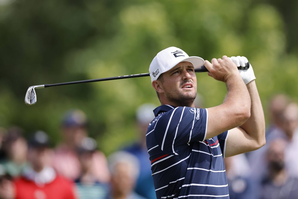 Golf player hits a tee shot at one of the holes during a game