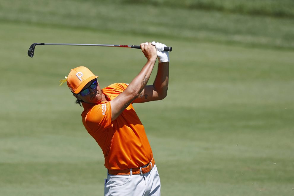 Baseball player hits an approach shot at one of the hole during a game