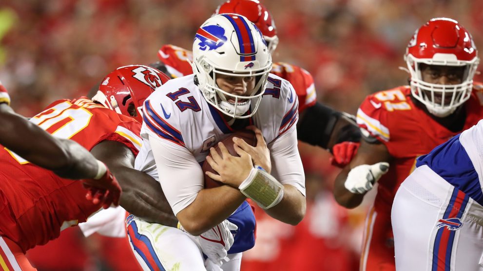 American football player runs the ball during a match