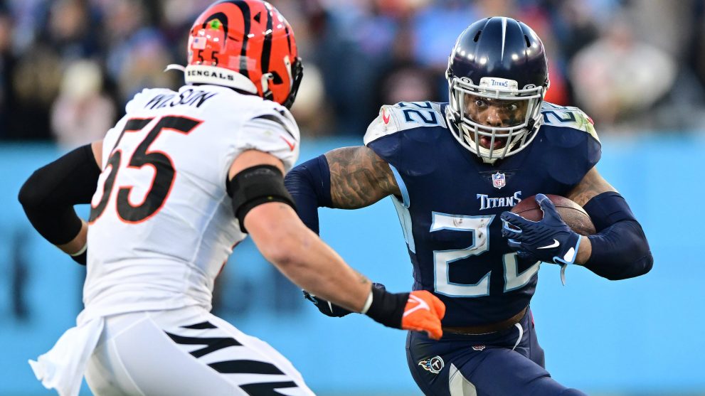 American football player runs the ball to a touch down during a match