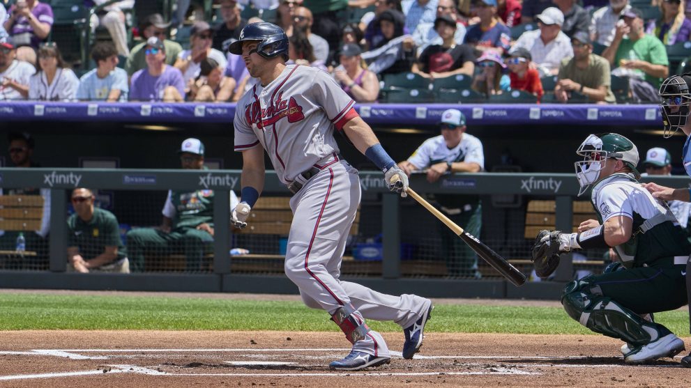 Baseball player runs after hitting the ball during a baseball game