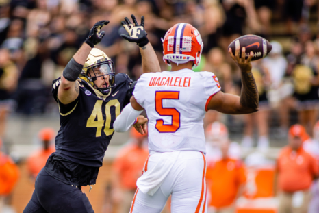 Clemson QB DJ Uiagalelei Throwing the Ball Under Pressure from a Wake Forest defender