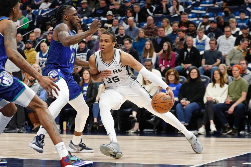 Basketball player dribbles the ball during a match