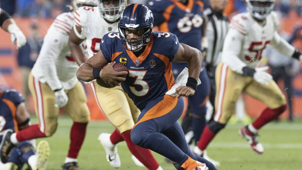 American football player runs to a touchdown during a match