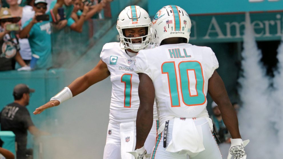 Two American football players talk on the field during a match