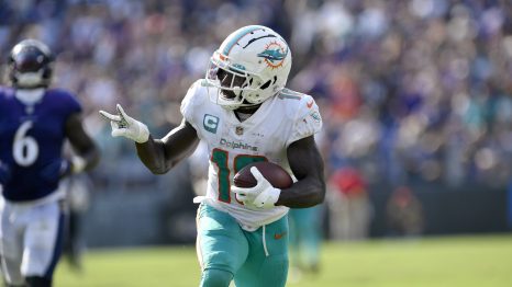 American football player runs the ball during a match