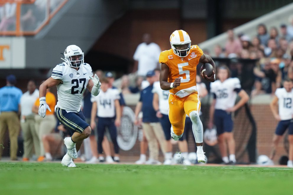 American football player runs the ball during a match