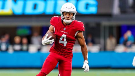 American football player catches the ball during a match