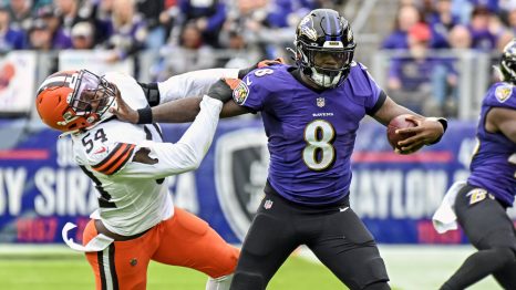 Two American football players fight for the ball during a match