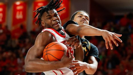 Basketball player faults the opposite team player who has the ball during a match