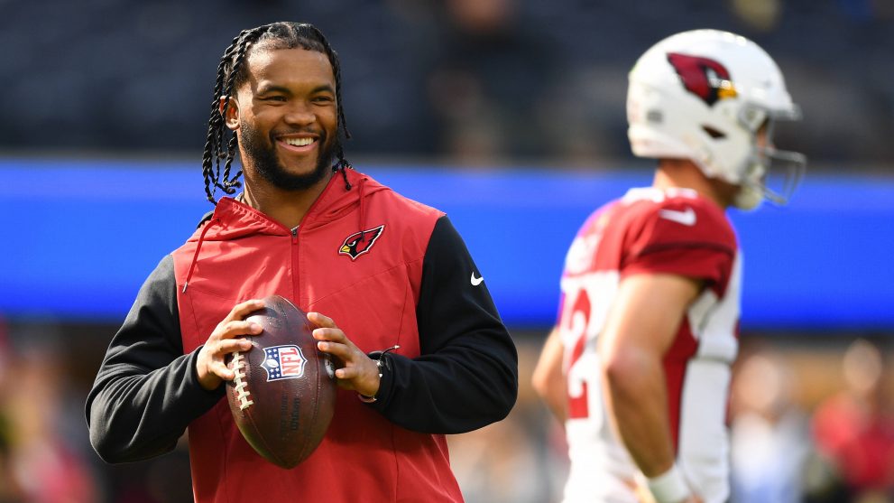 American football player with the ball in his hands outside of the game field