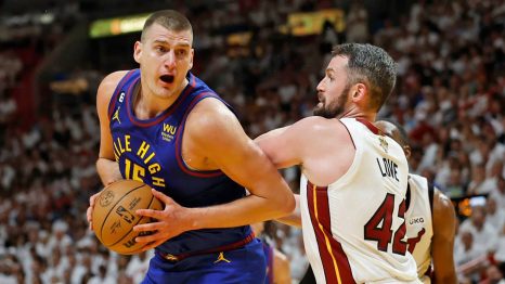 Basketball player faults an opposite team player during a match