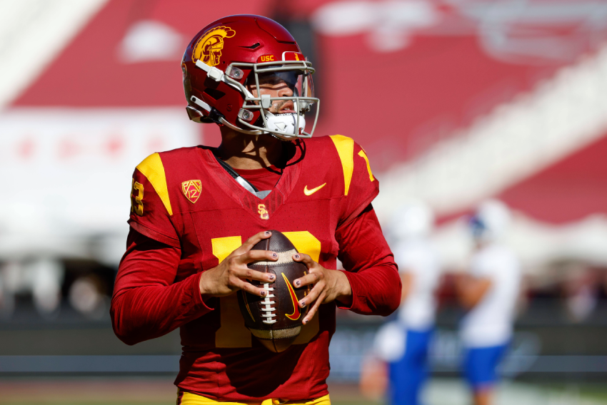 football player caleb williams holding the ball