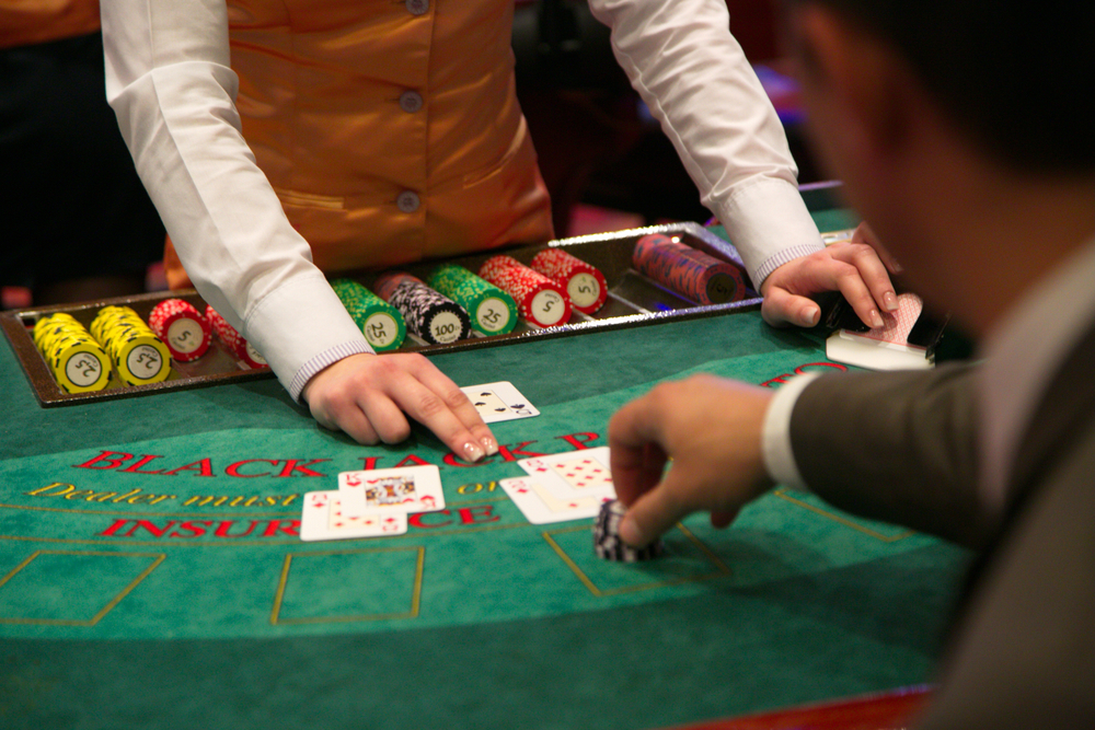 A casino player places his bets on a blackjack table