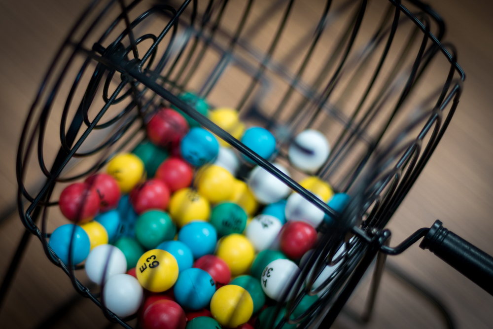 Multi-colored bingo balls in cage sitting on a desk
