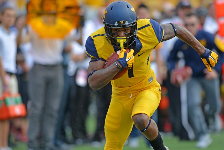 American Football player runs with the ball during a game