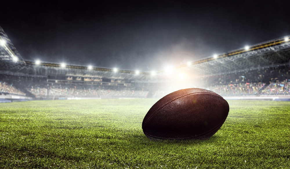 American football arena and a ball on the ground