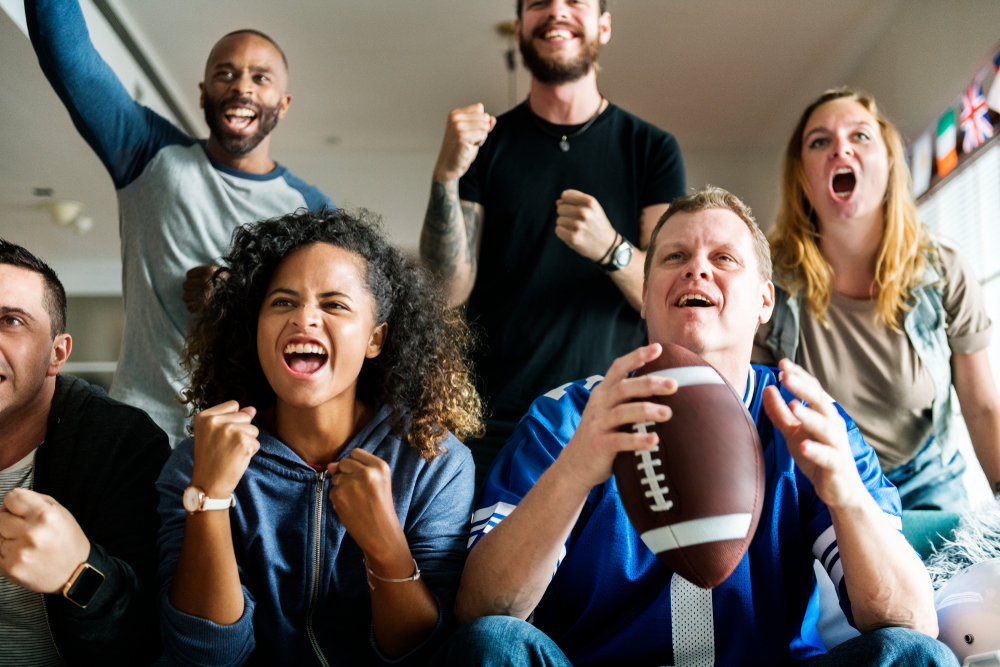 Friends cheering sport league together