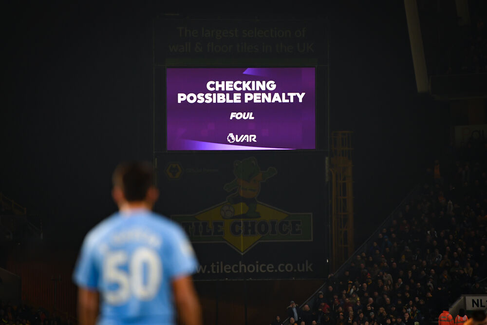 A stadium text announce - VAR checks for a possible penalty during a match