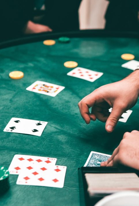 A dealer deals the poker cards an a table