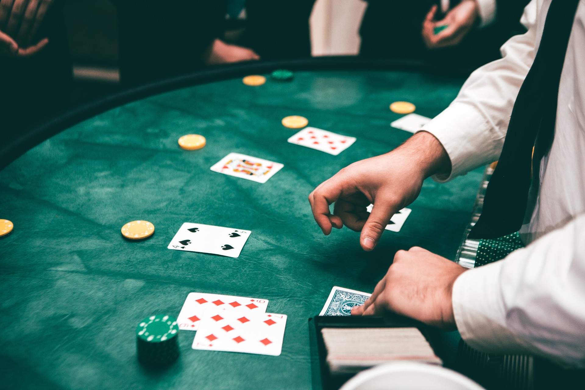 A dealer deals the poker cards an a table