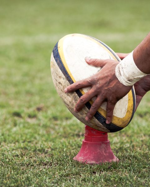 A rugby ball placed on a telescopic Kicking Tee by a player