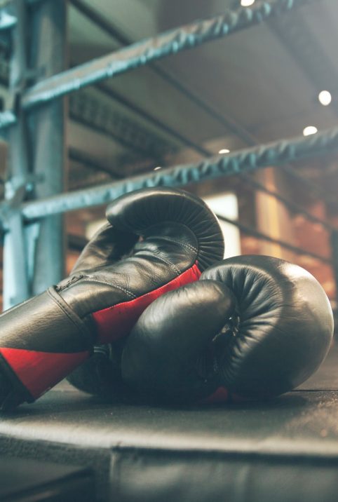 A pair of boxing gloves down in the ring corner