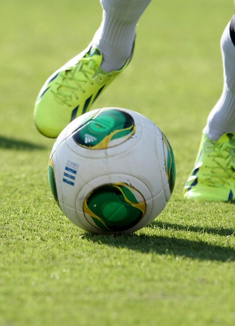 Feet of a football player run after a ball